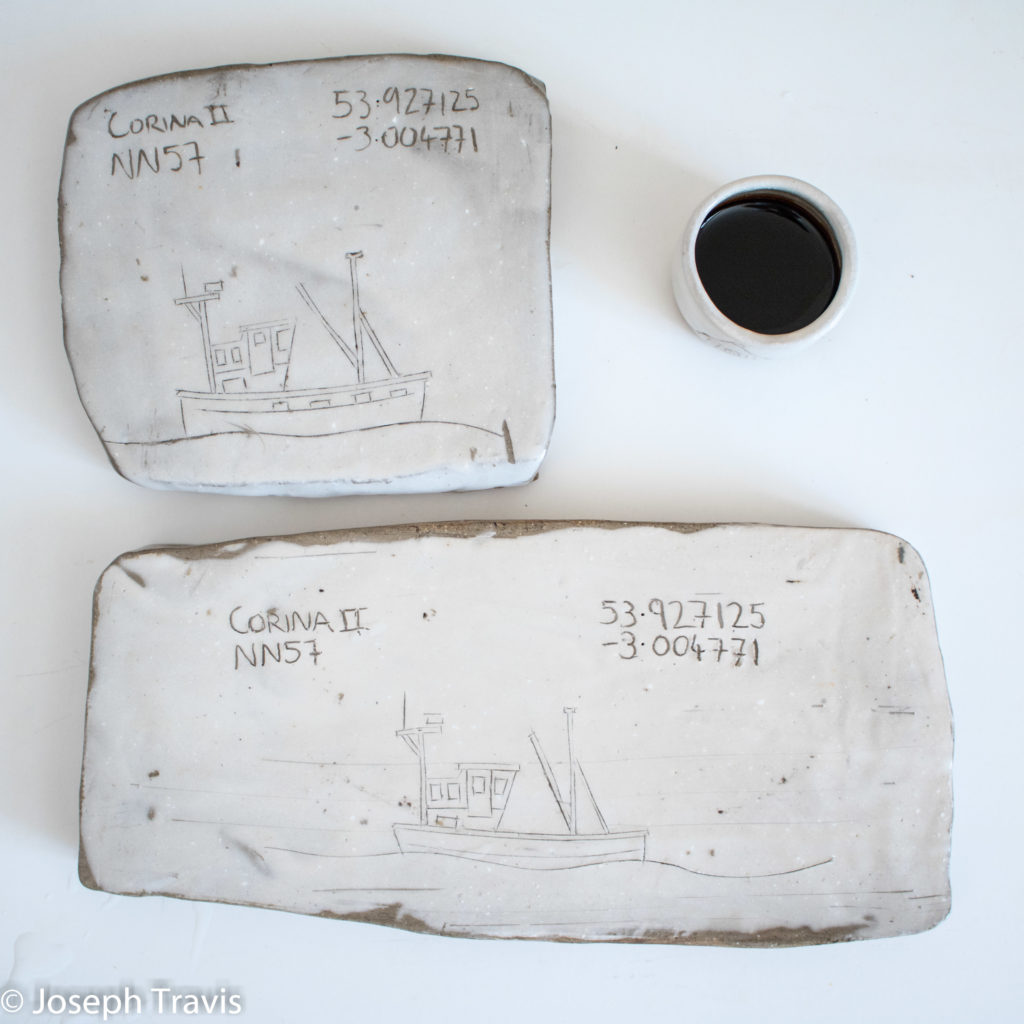 drawings of boats craved onto sushi platters